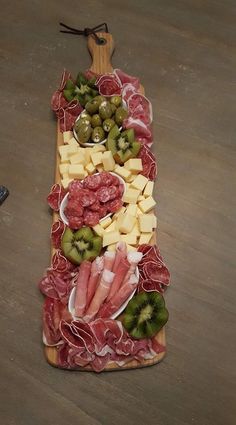 an assortment of meats and cheeses on a platter