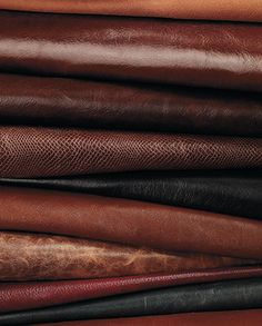 a pile of different colored leathers on top of each other