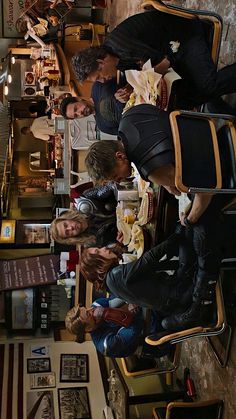 several people are sitting at a long table