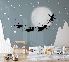 a child's bedroom decorated in black and white with fairy silhouettes flying over the moon