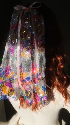 a white mannequin head with colorful sequins on it