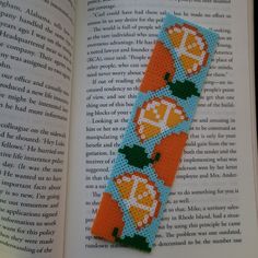 a bookmark made out of cross - stitch fabric with pumpkins and leaves on it