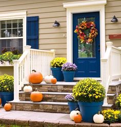 front porch decorated with pumpkins and flowers