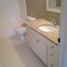 a bathroom with a sink, toilet and bathtub