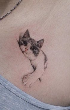 a woman with a cat tattoo on her stomach