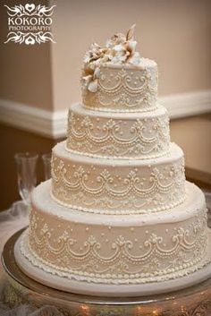 a three tiered wedding cake sitting on top of a table