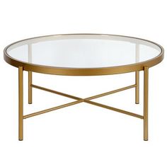 an oval glass coffee table with gold metal legs and a round glass top on a white background