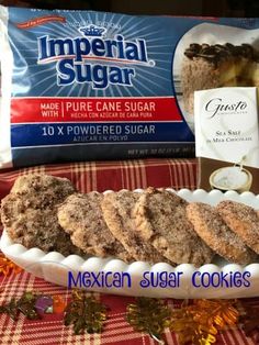 mexican sugar cookies on a plate next to an imperial sugar bag and box of pure cane sugar