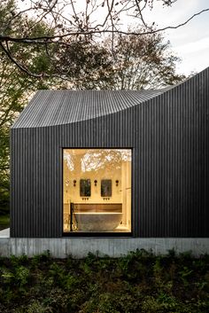 a black house with large windows on the outside