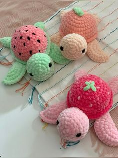 three crocheted stuffed animals sitting on top of a table