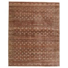 an antique rug with brown and beige colors