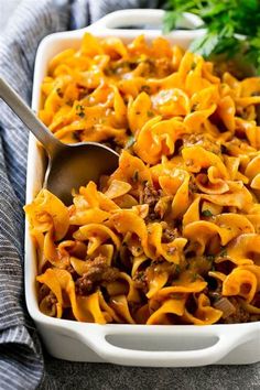 a casserole dish with meat, cheese and noodles in it on a table