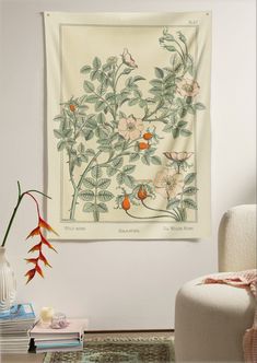 a room with a white chair and a tapestry hanging on the wall over a table