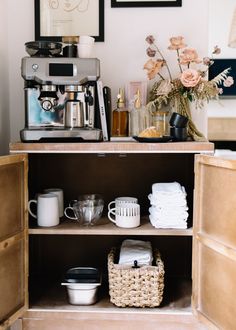 a coffee maker sitting on top of a wooden shelf