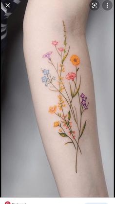 a woman's arm with flowers painted on it and the words merr sehen