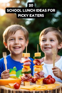 two young boys are smiling while holding small wooden skewers with food on them