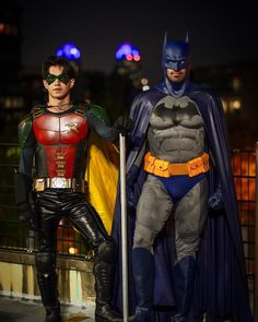 two men dressed up as batman and robin wayne standing next to each other in costumes