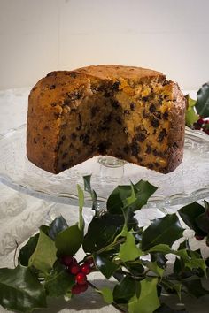 a piece of cake on a glass plate with holly