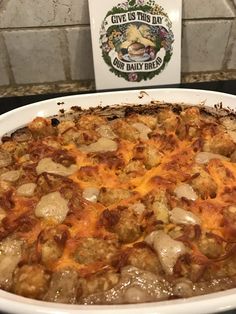 a large casserole dish with meat and cheese on the top, sitting on a counter