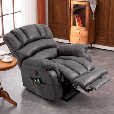 a reclining chair in a living room next to a table