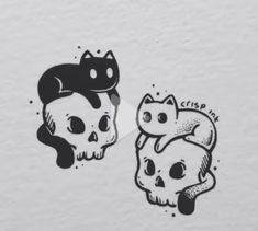 two skulls with cats on them and one skull has a cat in it's head