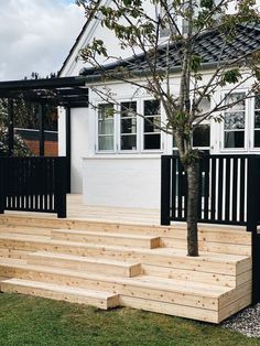 a wooden deck with steps leading up to a tree