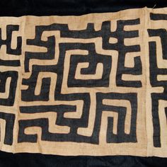 an old black and white piece of cloth that has been made into a maze pattern