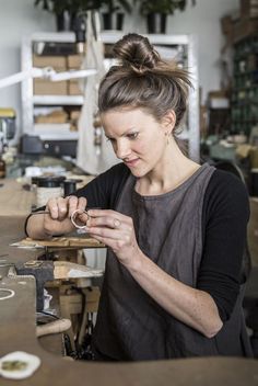 a woman working on something in a workshop