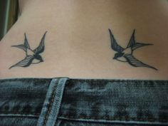 two birds are on the back of a woman's lower back neck and chest