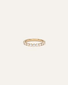 a gold ring with three diamonds on it