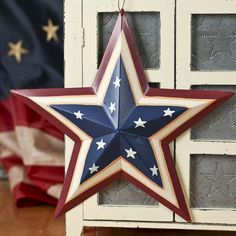 a red, white and blue star hanging from a window