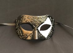 This men's Venetian masquerade mask has raised detail and is hand painted black and white. Mask is lightweight, durable, and has a comfortable fit. Comes with silk black ribbon ties attached. Mask is great for any Masquerade mask party! Black Formal Eye Mask Masquerade, Formal Black Eye Mask, Black Formal Eye Mask, Adjustable Black Masquerade Mask For Carnival, Black Adjustable Masquerade Mask For Carnival, Black Formal Masquerade Mask For Halloween, Black Venetian Mask For Masquerade, Black Venetian Masquerade Mask For Carnival, Black Venetian Mask For Carnival