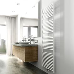 a bathroom with two sinks and a radiator