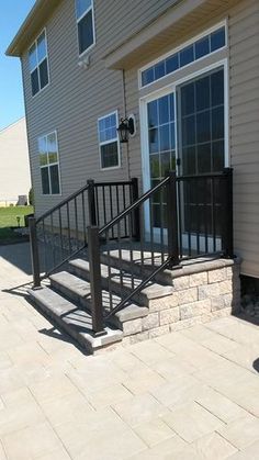 a house with a metal railing and stairs