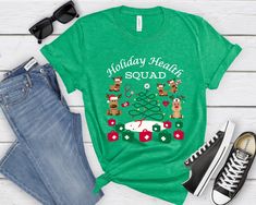 Premium quality, custom made to order Holiday Health Squad Shirt for the Health Office Team. Cute Reindeer shirt for any health office or medical clinic team. Perfect Holiday T-Shirt for all the health staff! 1) Select your choice of shirt color:  -White -Soft Cream -Athletic Heather (Light Grey) -Baby Blue -Kelly Green Note: Shirt colors come with font colors as pictured in images. 2) Select your size & add to cart 3) If purchasing more than one shirt, you will need to return to this page, make Nurse Team, Unisex Looks, Cookie Shirt, Snowman Shirt, Reindeer Shirt, Office Team, Office Shirt, Health Clinic, Nurse Christmas