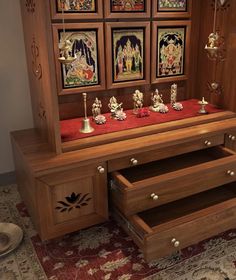 a wooden cabinet with drawers and pictures on the wall