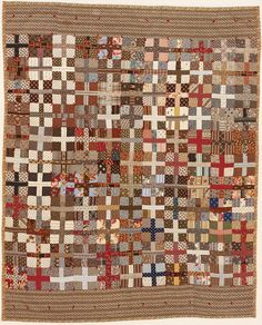 an old quilt with many squares and crosses on it