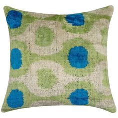 a green and blue pillow with circles on it