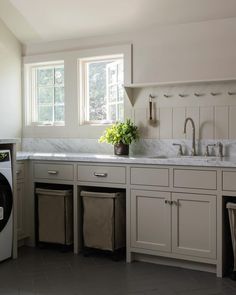 a washer and dryer in a white kitchen