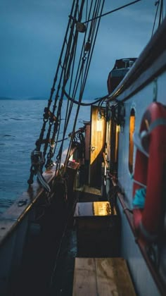 the deck of a boat at night with lights on