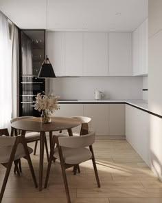 a dining table with four chairs around it in the middle of a kitchen next to a window