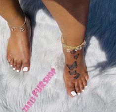 a woman's foot with butterfly tattoos on it