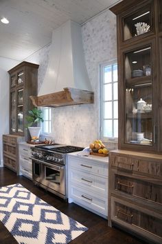 a kitchen with wooden cabinets and white walls