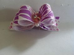 a purple and white bow with polka dots