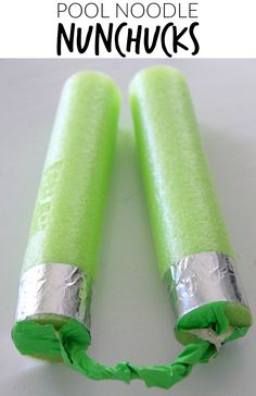 two green and silver tubes sitting on top of a white table next to each other