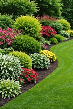 a garden with lots of green grass and colorful flowers