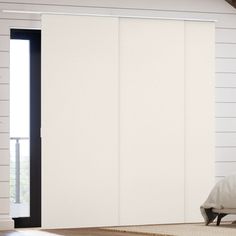 an open sliding door in a white room