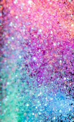 an abstract background with many colors and sparkles