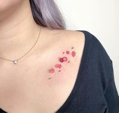 a close up of a woman's chest with small flowers on her left shoulder