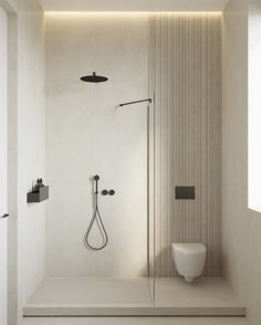 a bathroom with a toilet, shower head and standup shower in the middle of it